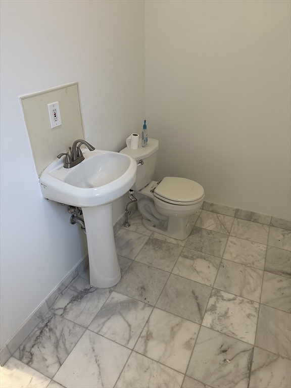 585 Massachusetts Avenue, Unit A Boston, MA 02118 - Photo 6 of 8 a bathroom with a sink toilet and a mirror