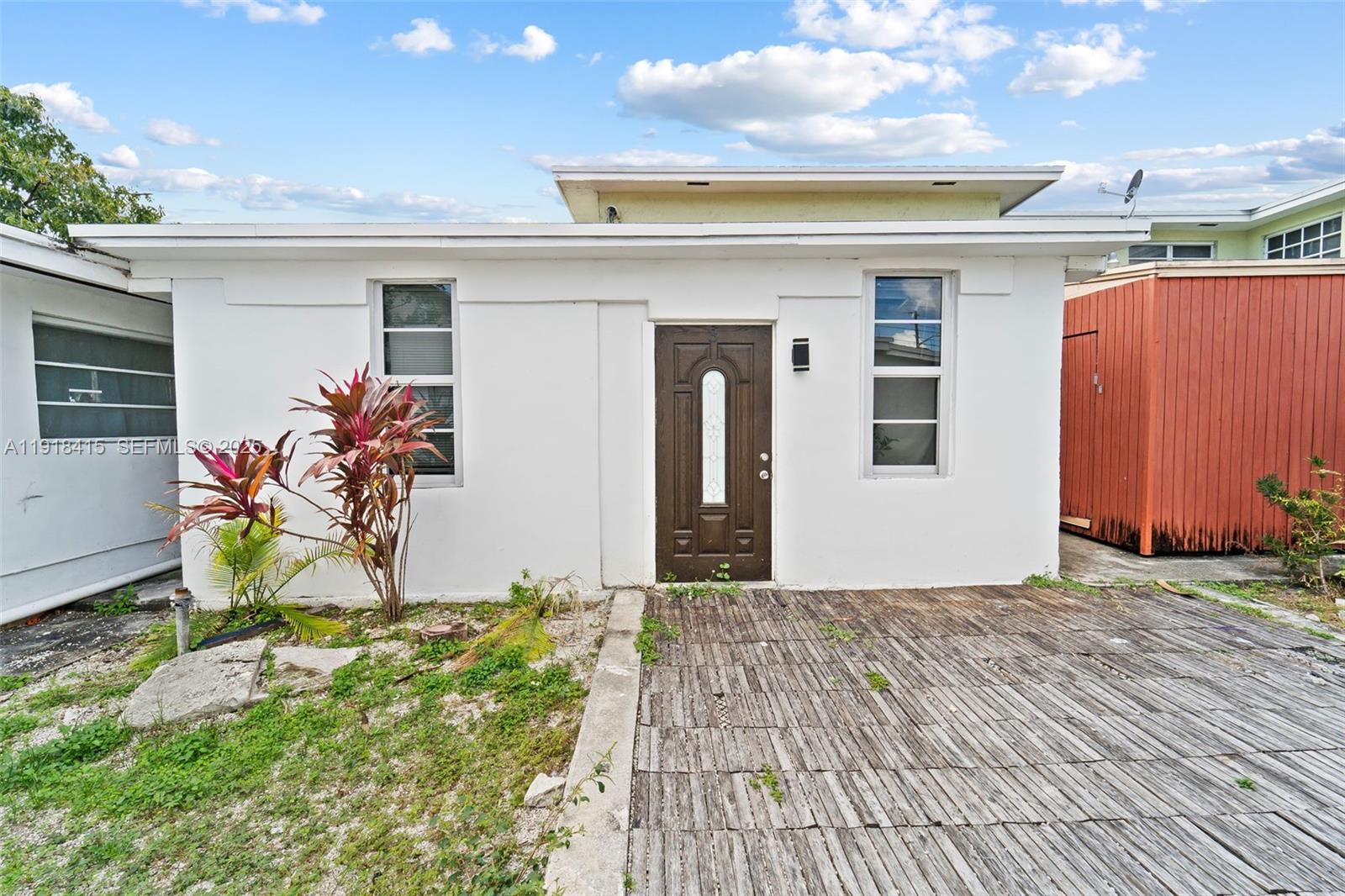 634 Southwest 10th Avenue Miami, FL 33130 - Photo 4 of 10 a view of a porch with wooden floor and a refrigerator