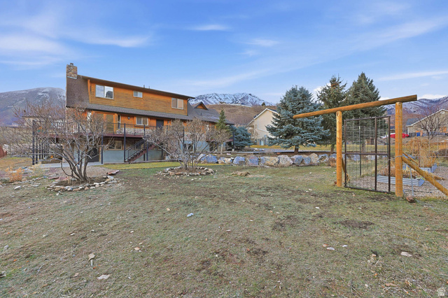 605 North Loafer Canyon Road Elk Ridge, UT 84651 - Photo 47 of 53 View of grassy yard with a deck with mountain view and stairs