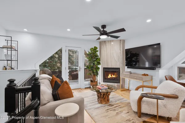 a living room with fireplace furniture and a flat screen tv