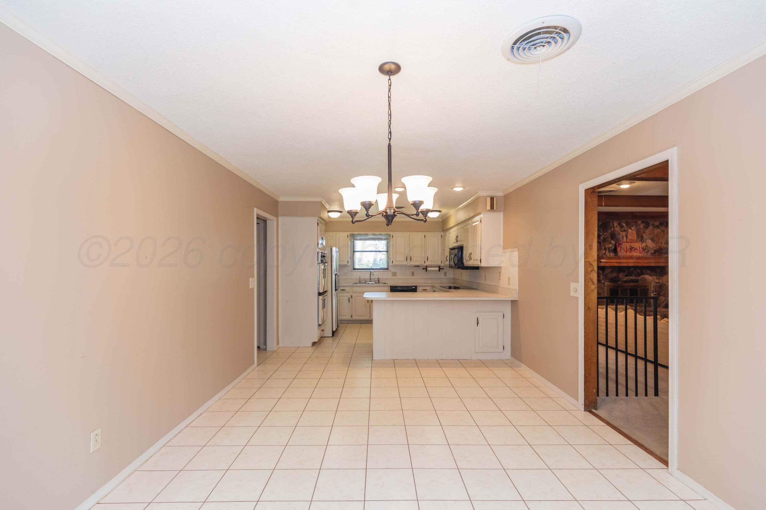 410 Creekside Drive Amarillo, TX 79124 - Photo 13 of 46 a large white kitchen with a window and cabinetry