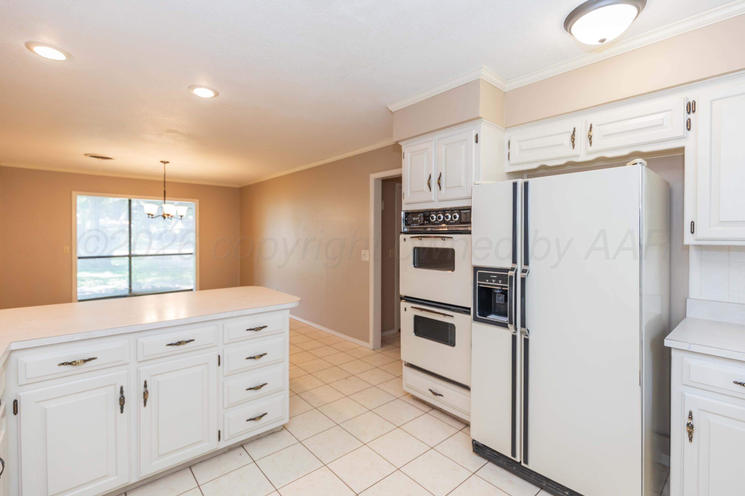 410 Creekside Drive Amarillo, TX 79124 - Photo 18 of 46 a kitchen with granite countertop cabinets and refrigerator
