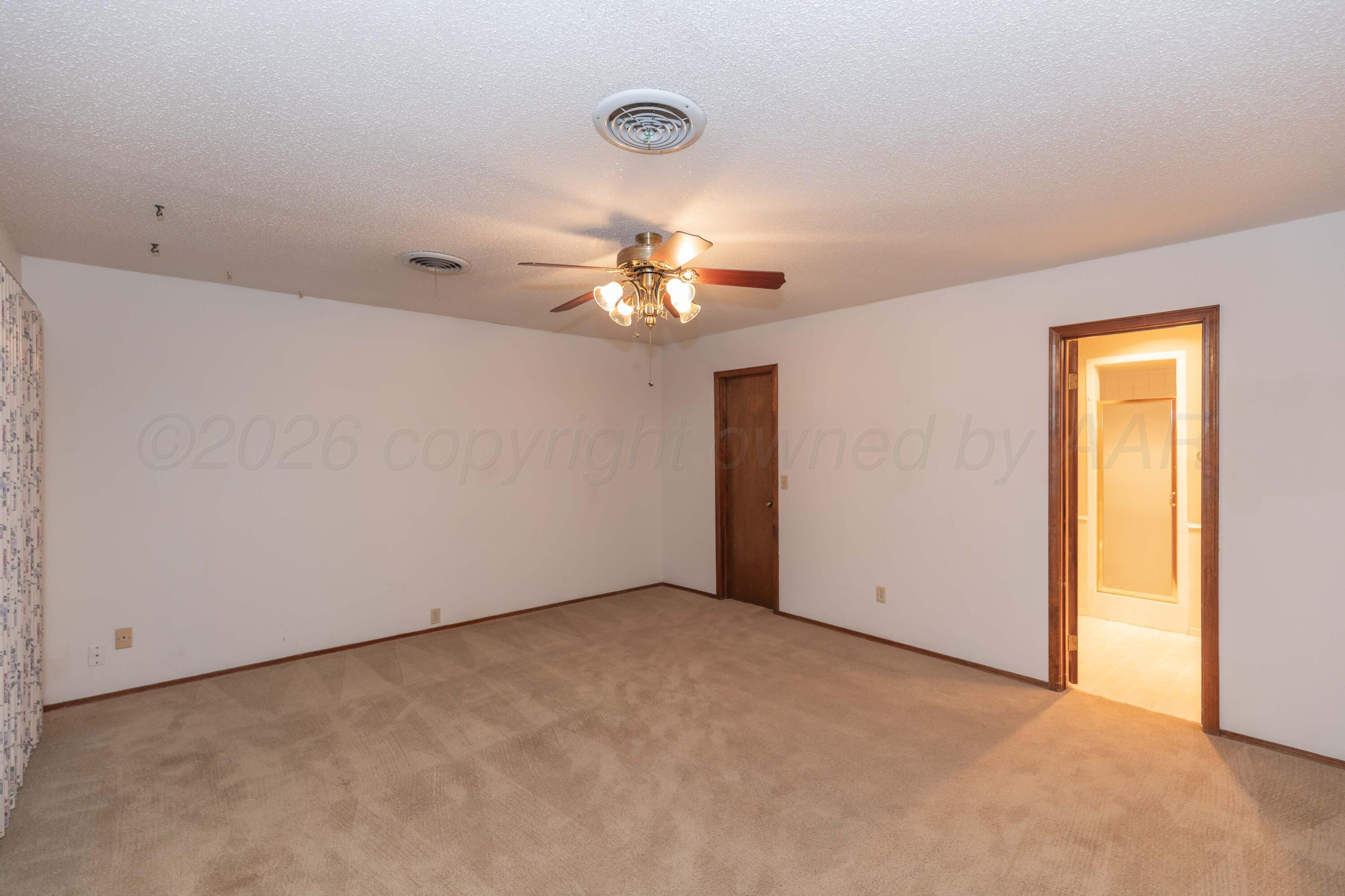 410 Creekside Drive Amarillo, TX 79124 - Photo 24 of 46 a view of an empty room with a chandelier fan