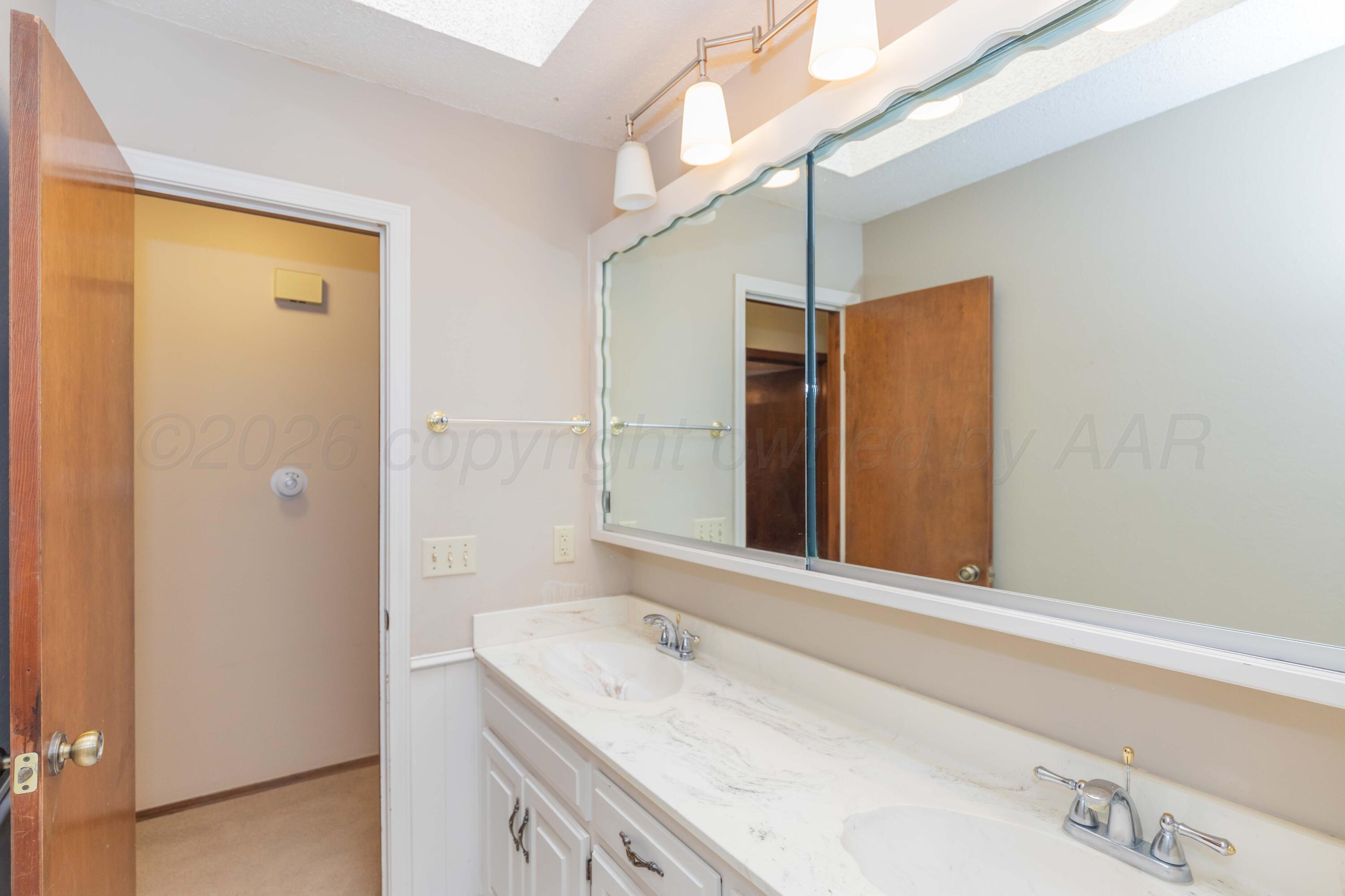 410 Creekside Drive Amarillo, TX 79124 - Photo 39 of 46 a bathroom with a granite countertop sink and a mirror