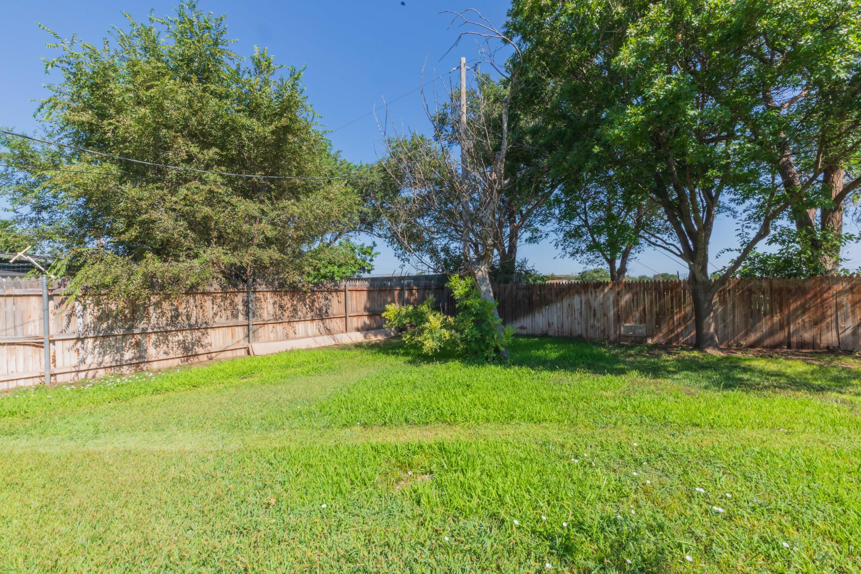410 Creekside Drive Amarillo, TX 79124 - Photo 40 of 46 a view of a backyard with large trees