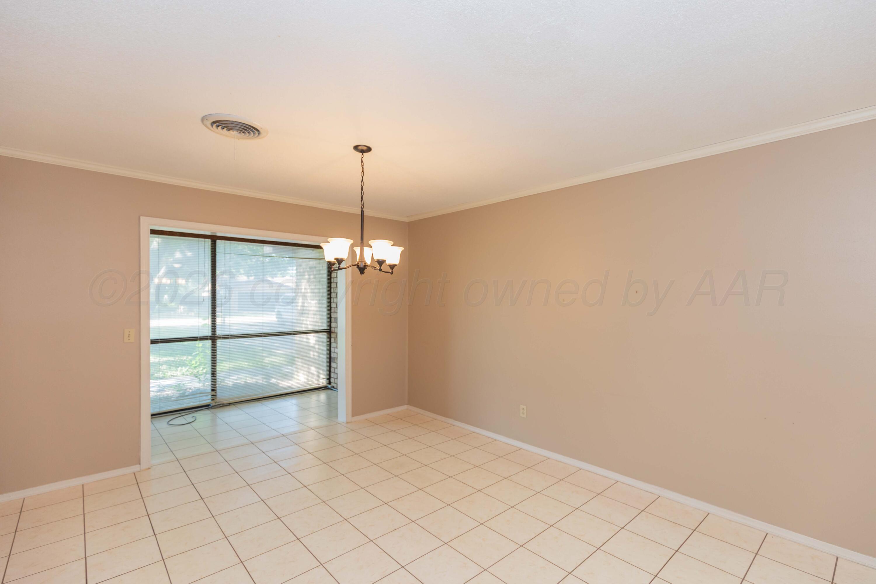 410 Creekside Drive Amarillo, TX 79124 - Photo 10 of 46 an empty room with windows and ceiling fan
