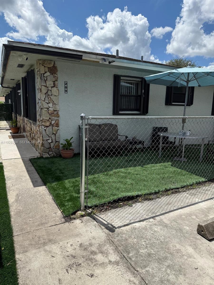 208 Northwest 7th Street, Unit 12 Hallandale Beach, FL 33009 - Photo 5 of 15 a view of a back yard of the house