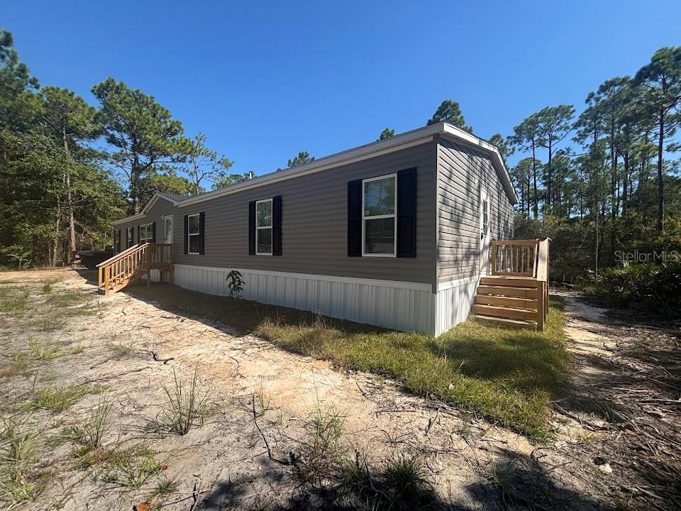 25 Mario Road Santa Rosa Beach, FL 32459 - Photo 2 of 12 a view of a house with a yard