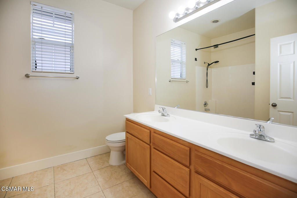 1129 Azalea Way Simi Valley, CA 93065 - Photo 39 of 49 a bathroom with a sink and a mirror with toilet