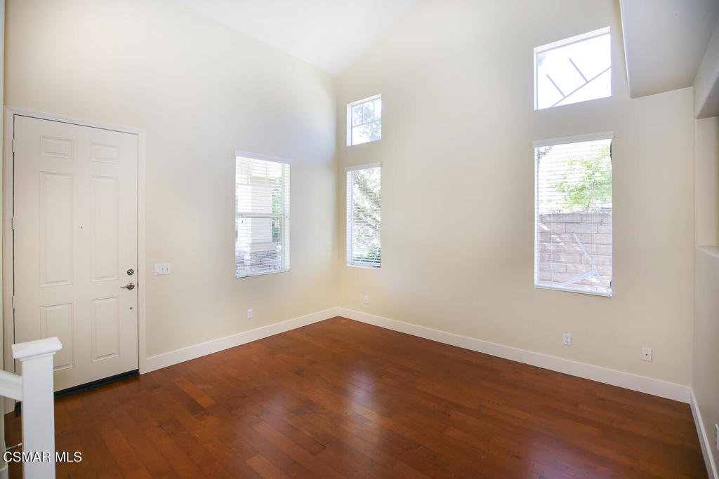 1129 Azalea Way Simi Valley, CA 93065 - Photo 6 of 49 an empty room with wooden floor and windows