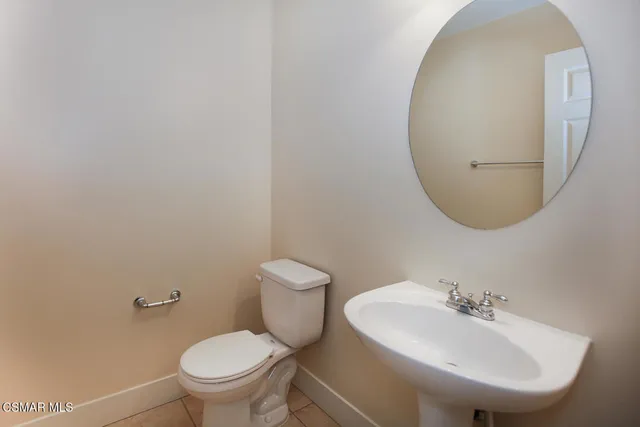 a bathroom with a sink a mirror and toilet