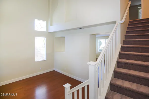 a view of an entryway with wooden floor and stairs