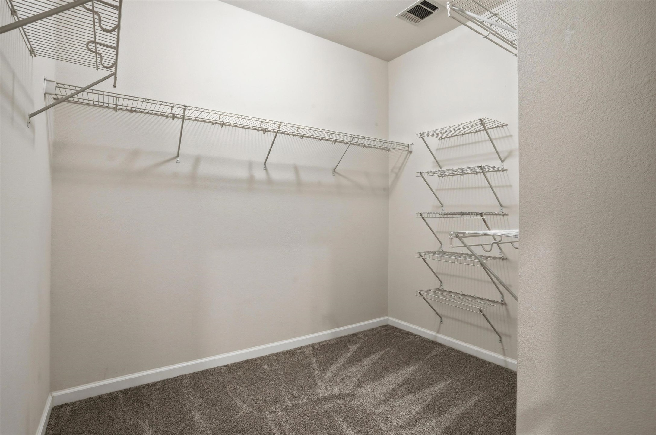 11606 Murchison Street Manor, TX 78653 - Photo 17 of 35 This spacious closet features wire shelving for organized storage just off the primary bathroom