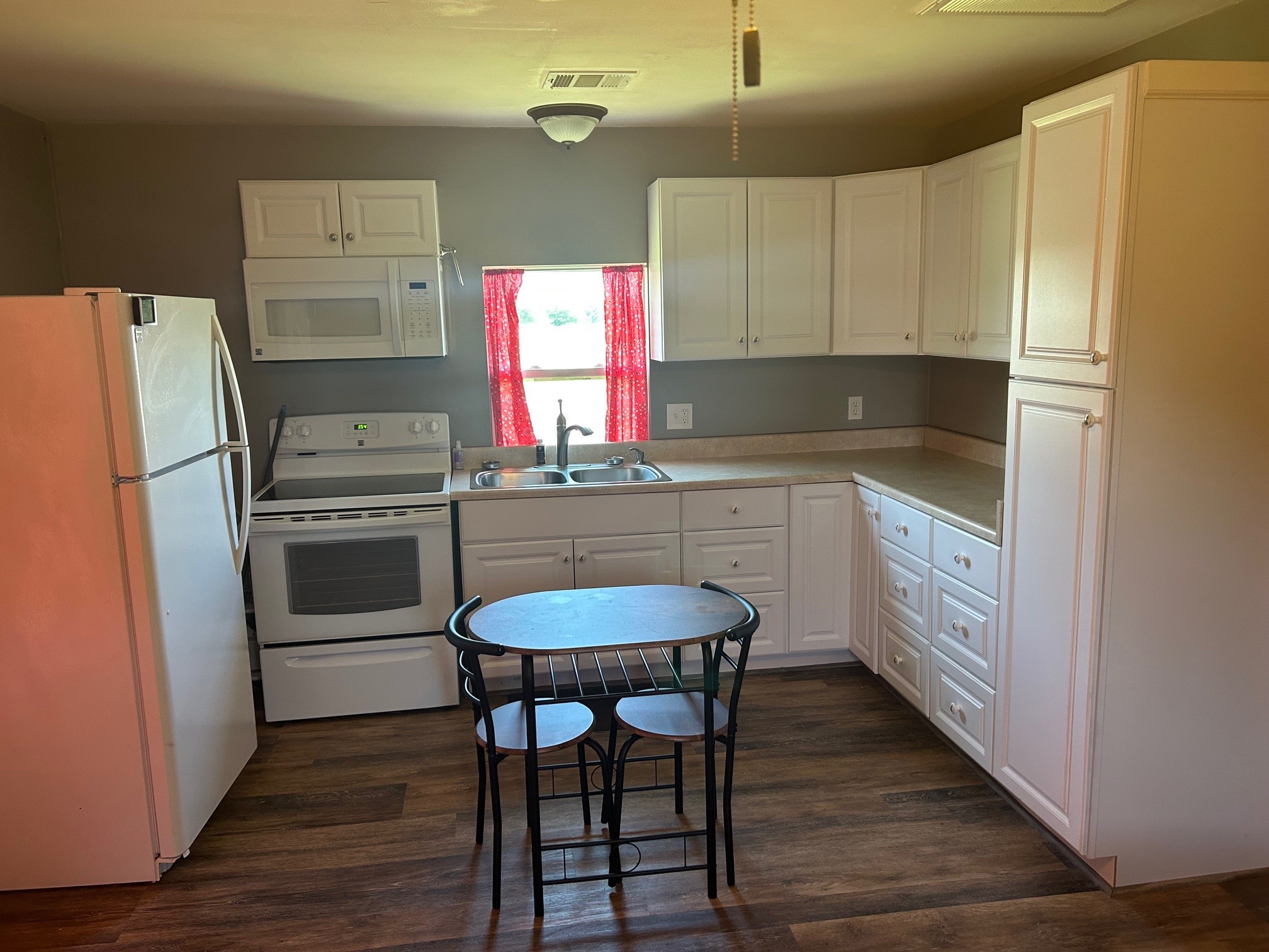 38094 Joe Loggins Road Hempstead, TX 77445 - Photo 17 of 32 a kitchen with stainless steel appliances a stove a sink refrigerator and cabinets