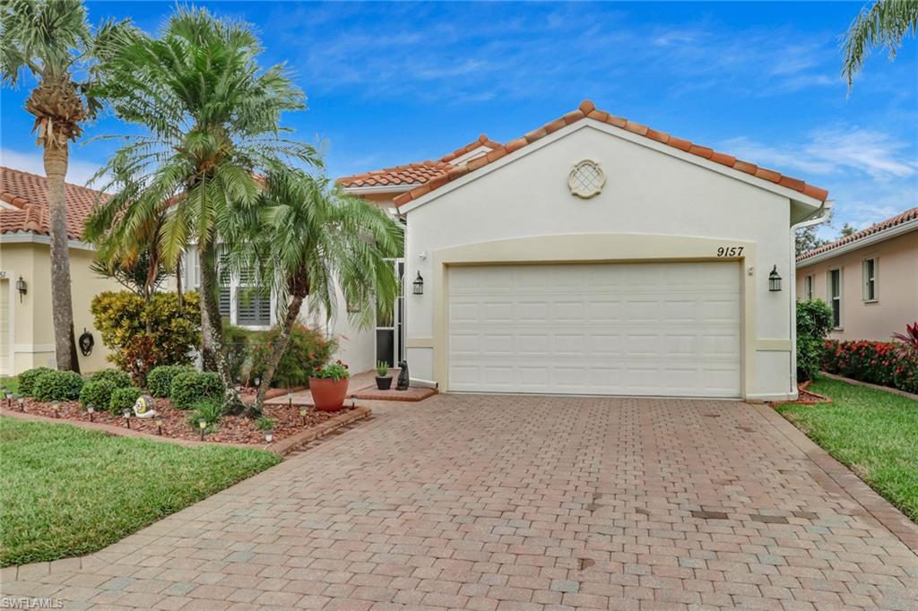 9157 Springview Loop Estero, FL 33928 - Photo 1 of 47 a view of a house with a yard and potted plants