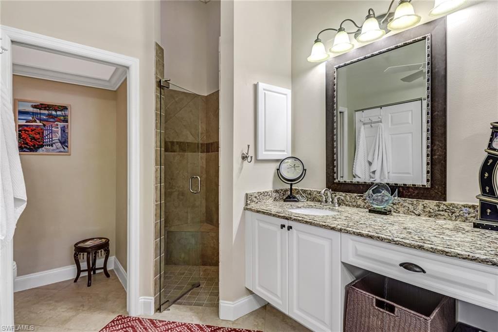 9157 Springview Loop Estero, FL 33928 - Photo 13 of 47 a bathroom with a granite countertop sink a mirror and a shower