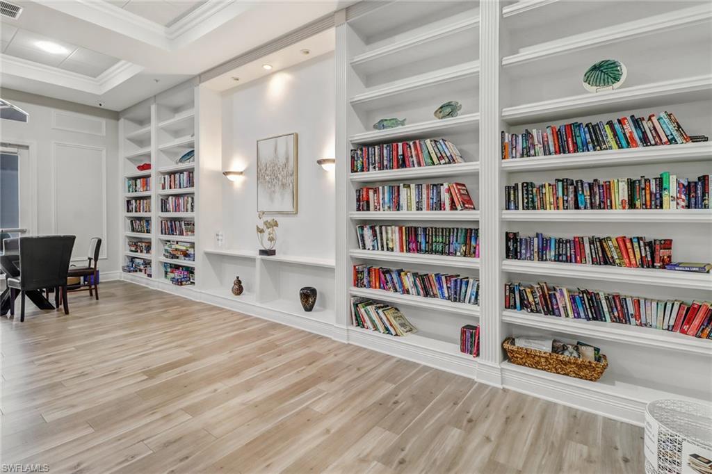 9157 Springview Loop Estero, FL 33928 - Photo 29 of 47 a room with bookshelf and a wooden floor