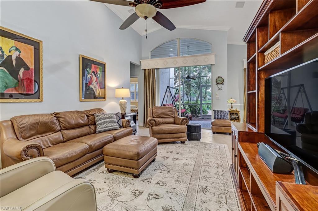 9157 Springview Loop Estero, FL 33928 - Photo 3 of 47 a living room with furniture or couch and a flat screen tv