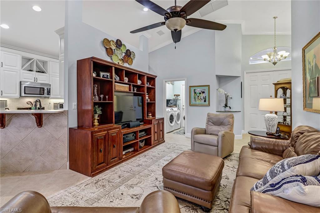 9157 Springview Loop Estero, FL 33928 - Photo 5 of 47 a living room with furniture and a flat screen tv