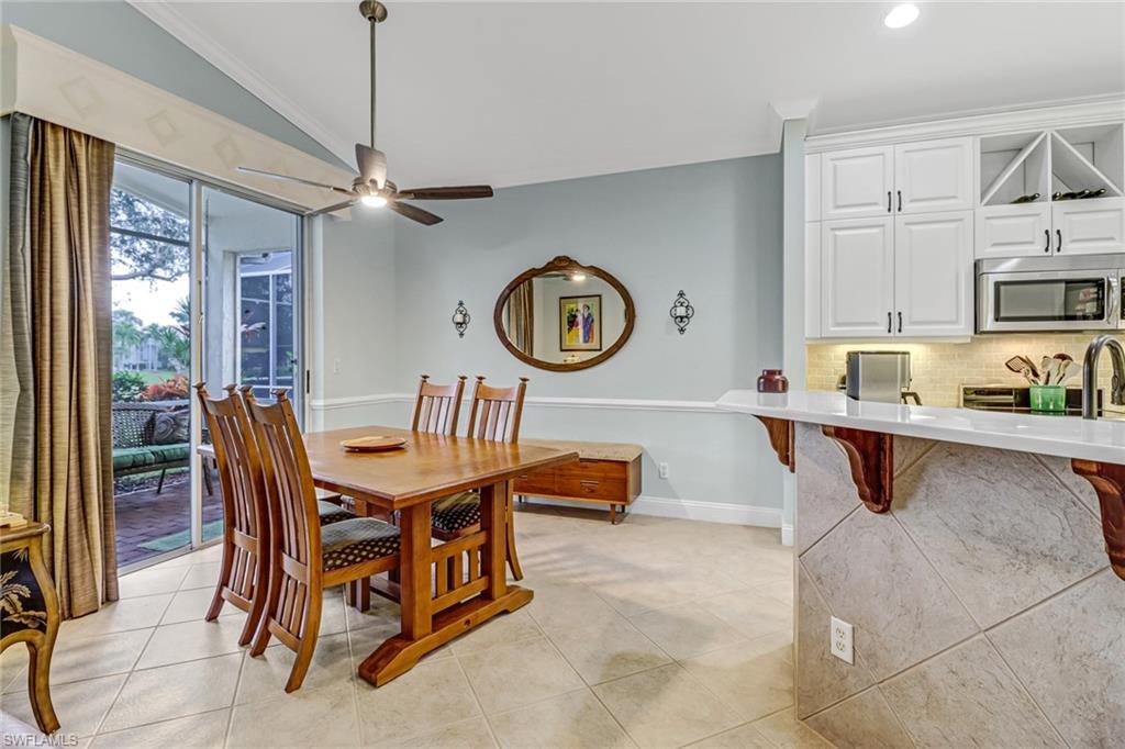 9157 Springview Loop Estero, FL 33928 - Photo 10 of 47 a view of kitchen and dining area with furniture