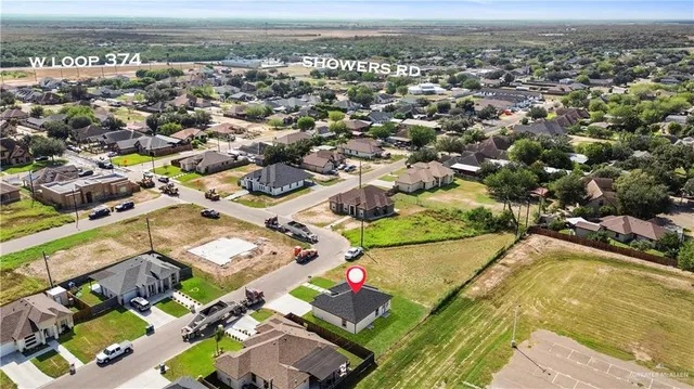 an aerial view of residential houses with outdoor space