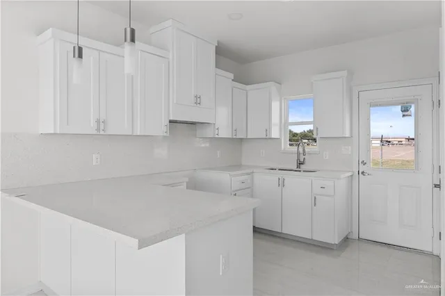 a kitchen with white cabinets and white appliances