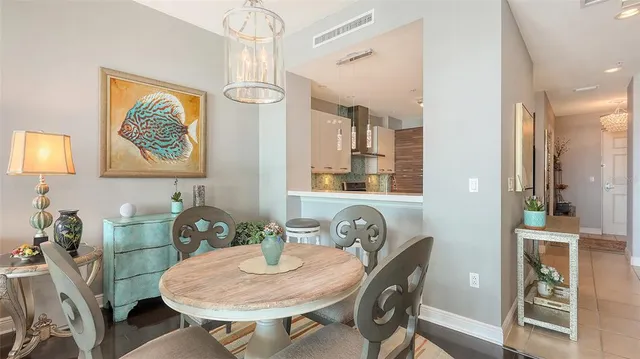 a living room with furniture a chandelier and a chandelier