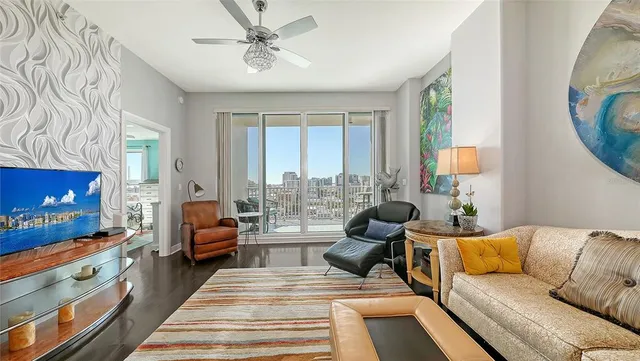 a living room with furniture a rug and a flat screen tv