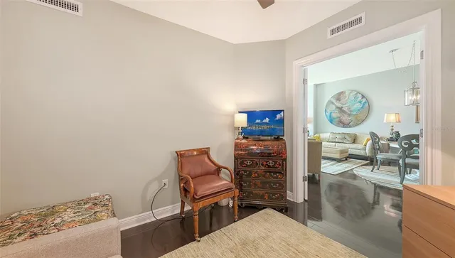 a bedroom with a bed a couch and a window