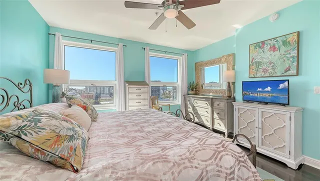 a bedroom with a bed and a flat tv screen on dresser