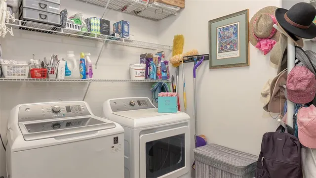 a living room with couch and a dining table with garden view