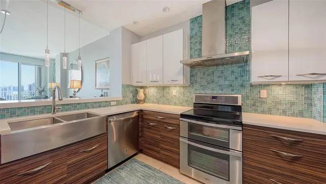 a kitchen with stainless steel appliances granite countertop a refrigerator and a stove