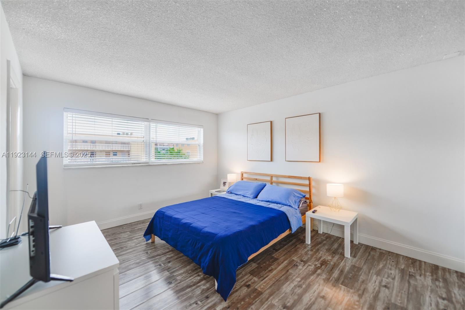 200 Northeast 12th Avenue, Unit 6D Hallandale Beach, FL 33009 - Photo 15 of 36 a bedroom with a bed and a window