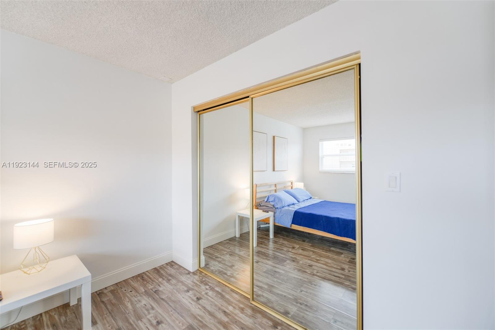200 Northeast 12th Avenue, Unit 6D Hallandale Beach, FL 33009 - Photo 16 of 36 a view of a room that has a bed and wooden floor