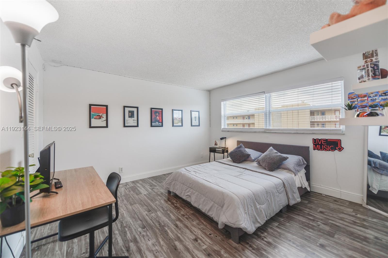 200 Northeast 12th Avenue, Unit 6D Hallandale Beach, FL 33009 - Photo 19 of 36 a bedroom with a bed and a table