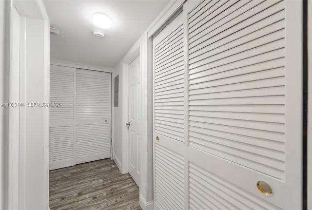 a view of a hallway with wooden floor
