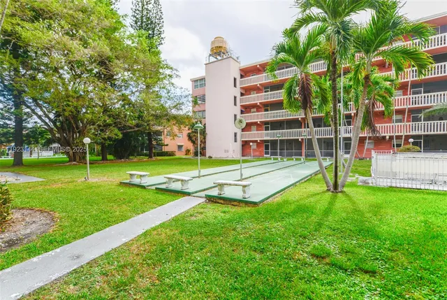 a view of a house with a yard and sitting area
