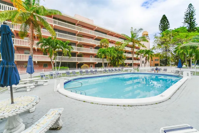 a swimming pool with outdoor seating and yard