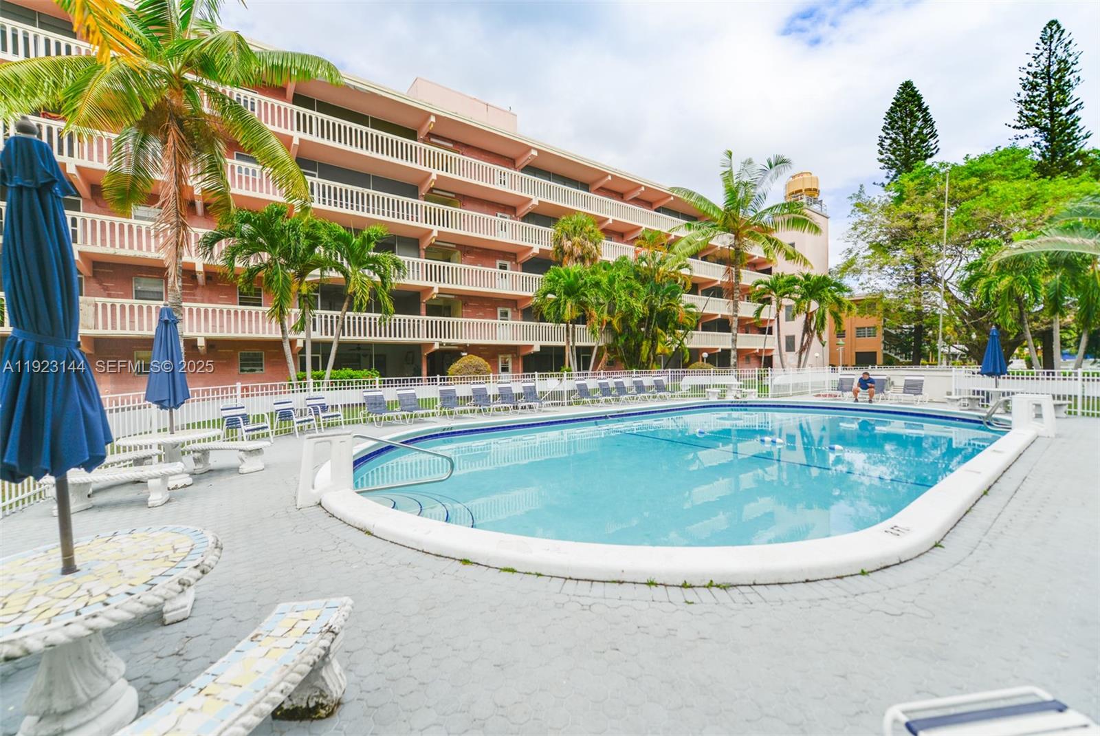 200 Northeast 12th Avenue, Unit 6D Hallandale Beach, FL 33009 - Photo 35 of 36 a swimming pool with outdoor seating and yard
