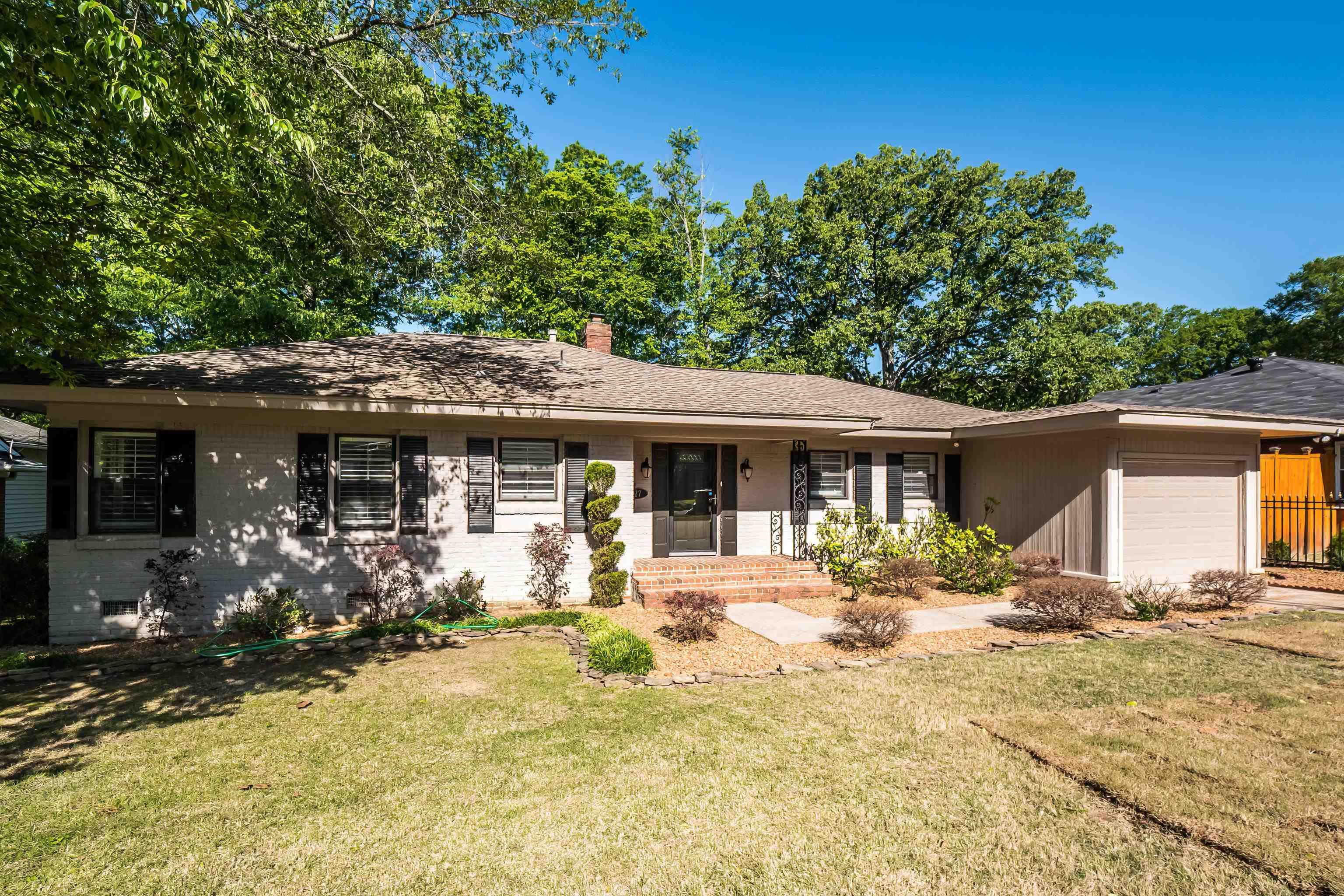 a front view of a house with a yard outdoor seating and garage