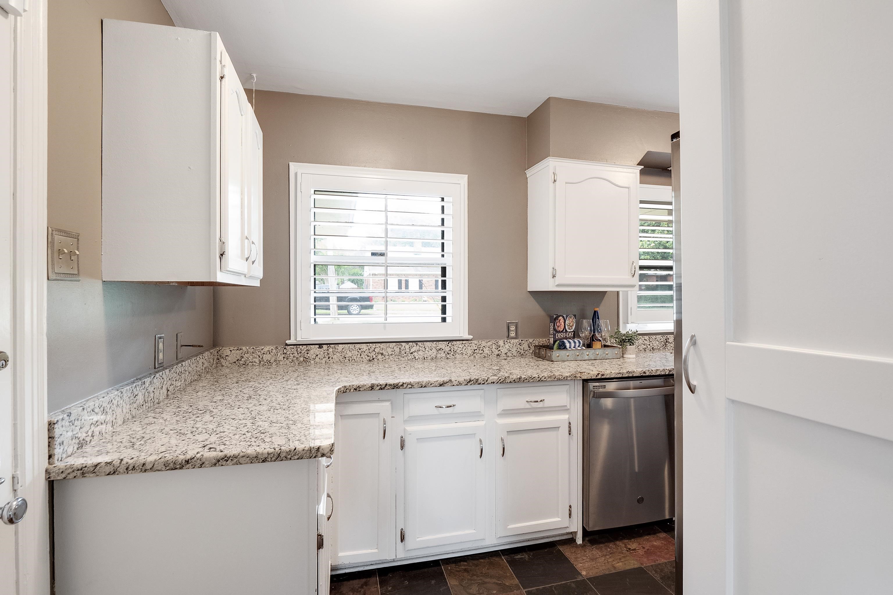 227 Wallace Road Memphis, TN 38117 - Photo 8 of 25 a kitchen with granite countertop cabinets stainless steel appliances a sink and a window