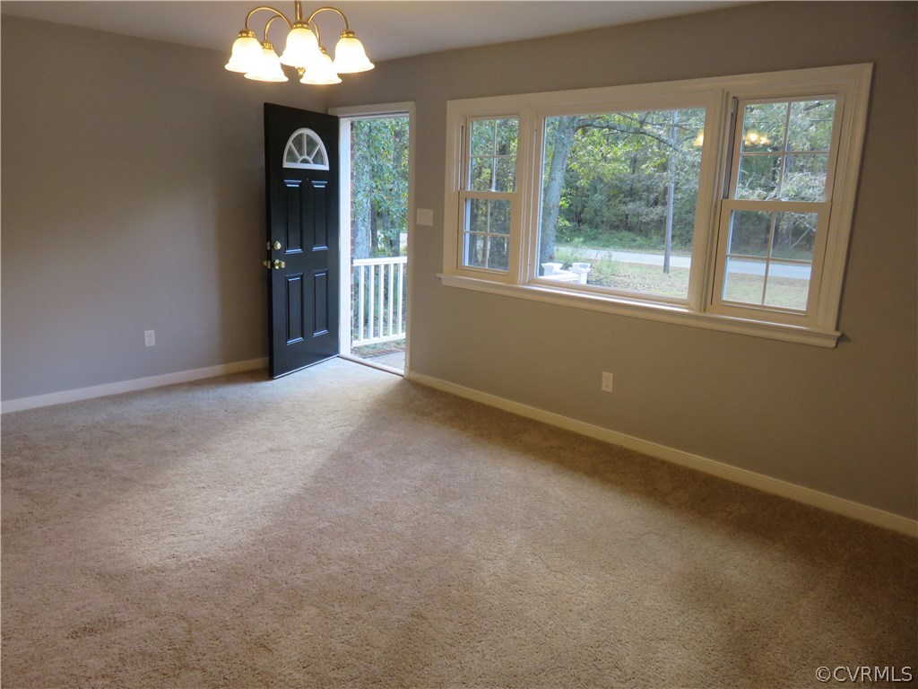 8573 Strath Road Henrico, VA 23231 - Photo 12 of 37 an empty room with a window and chandelier
