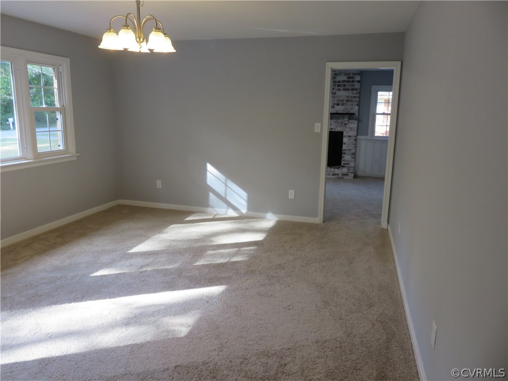 8573 Strath Road Henrico, VA 23231 - Photo 14 of 37 a view of a livingroom with a chandelier fan and a window