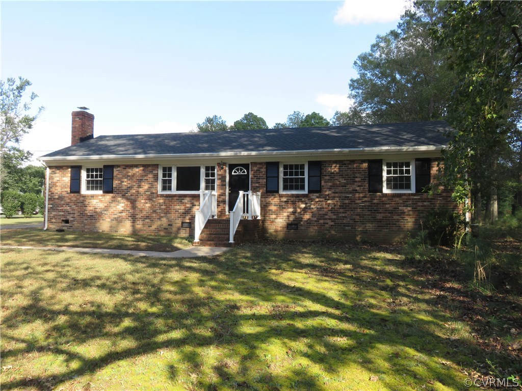 8573 Strath Road Henrico, VA 23231 - Photo 2 of 37 a front view of a house with a yard table and chairs