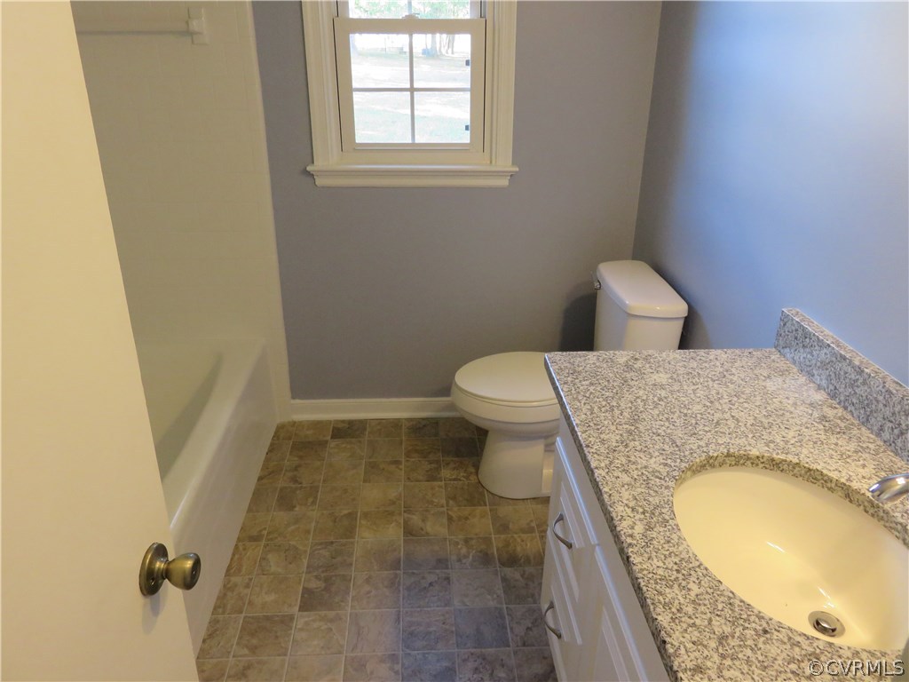 8573 Strath Road Henrico, VA 23231 - Photo 23 of 37 a bathroom with a granite countertop sink and a mirror