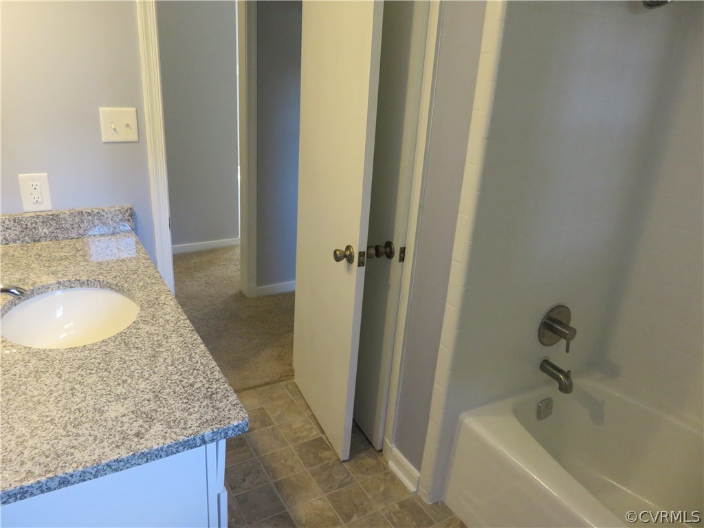 8573 Strath Road Henrico, VA 23231 - Photo 25 of 37 a bathroom with a granite countertop sink and a mirror