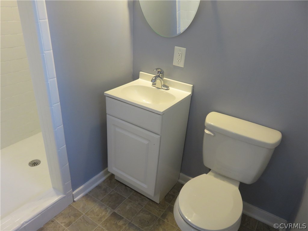 8573 Strath Road Henrico, VA 23231 - Photo 28 of 37 a white toilet sitting next to a bathroom sink