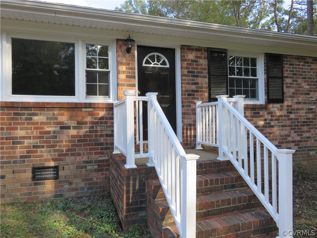 8573 Strath Road Henrico, VA 23231 - Photo 9 of 37 a view of a brick house that has lots of windows