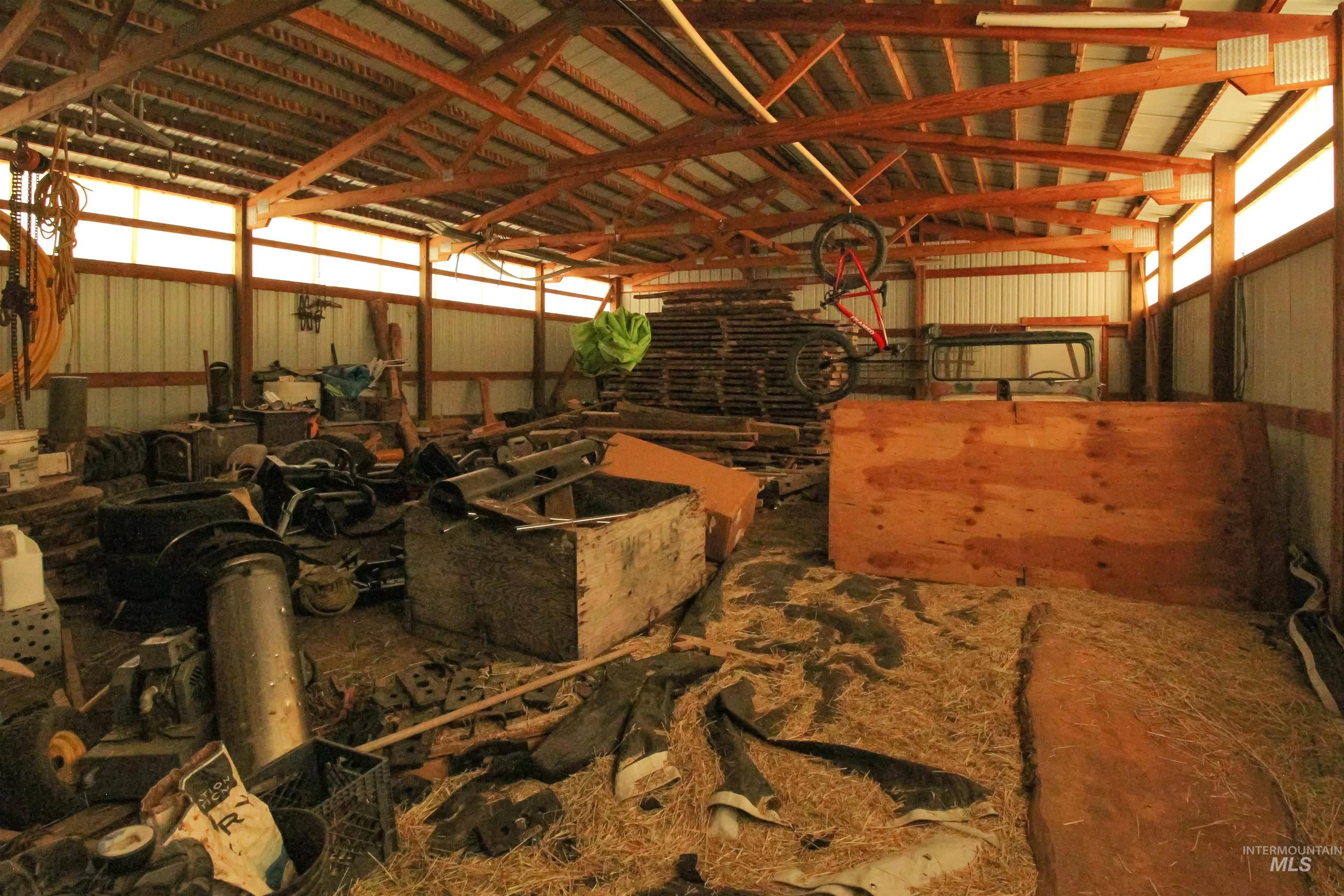 2469 Hague Road Midvale, ID 83645 - Photo 36 of 50 Multiple metal-clad outbuildings, each featuring corrugated metal siding and a pitched roof