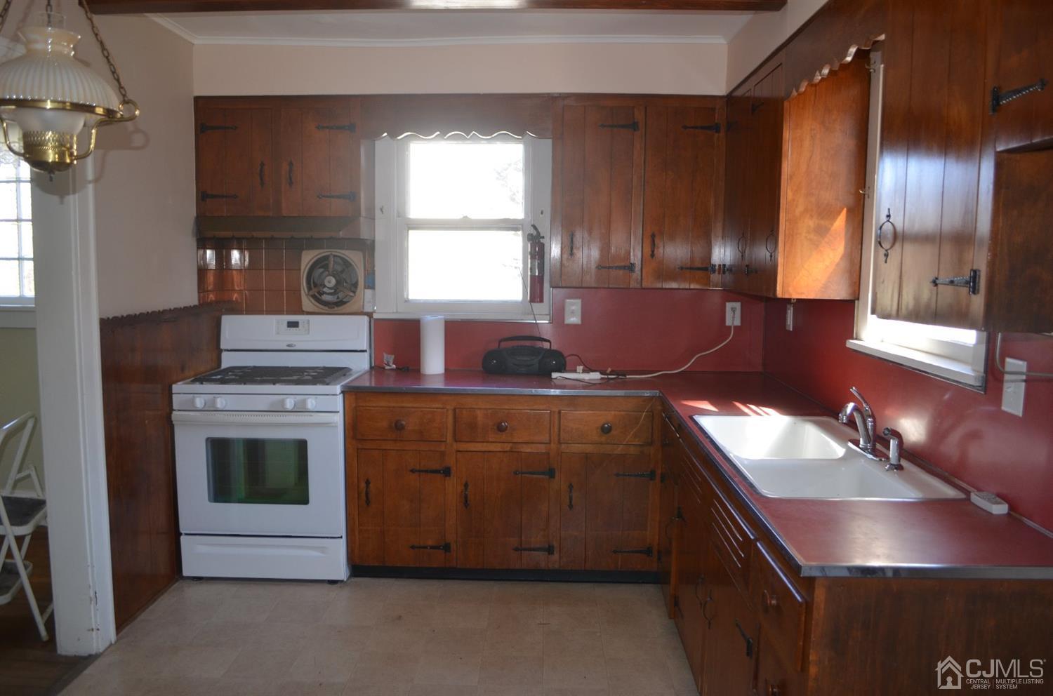 75 West Hill Road Colonia, NJ 07067 - Photo 12 of 35 a kitchen with stainless steel appliances granite countertop a sink stove and cabinets